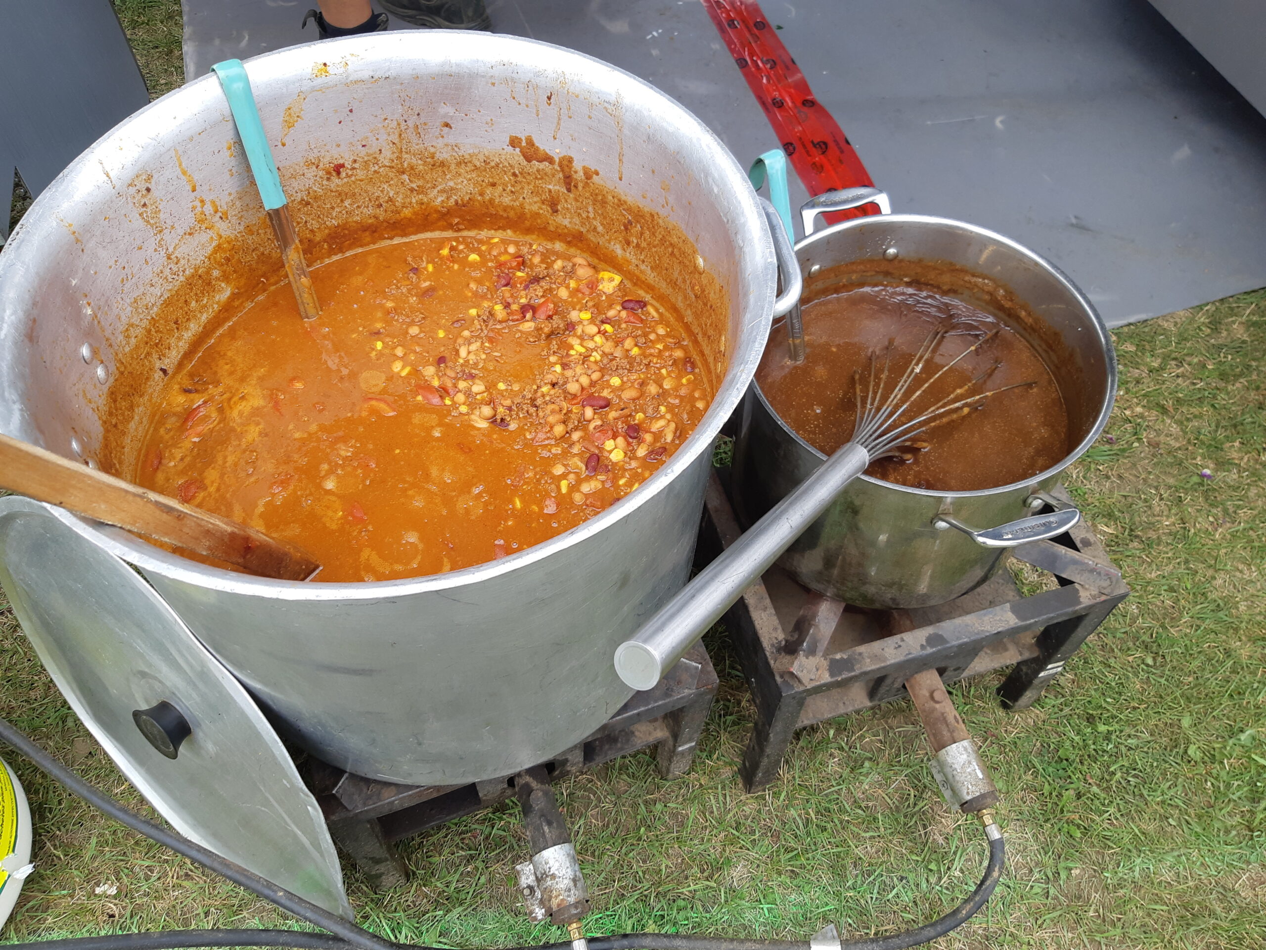 20220730_115336 A pot of chili being cooked outside.