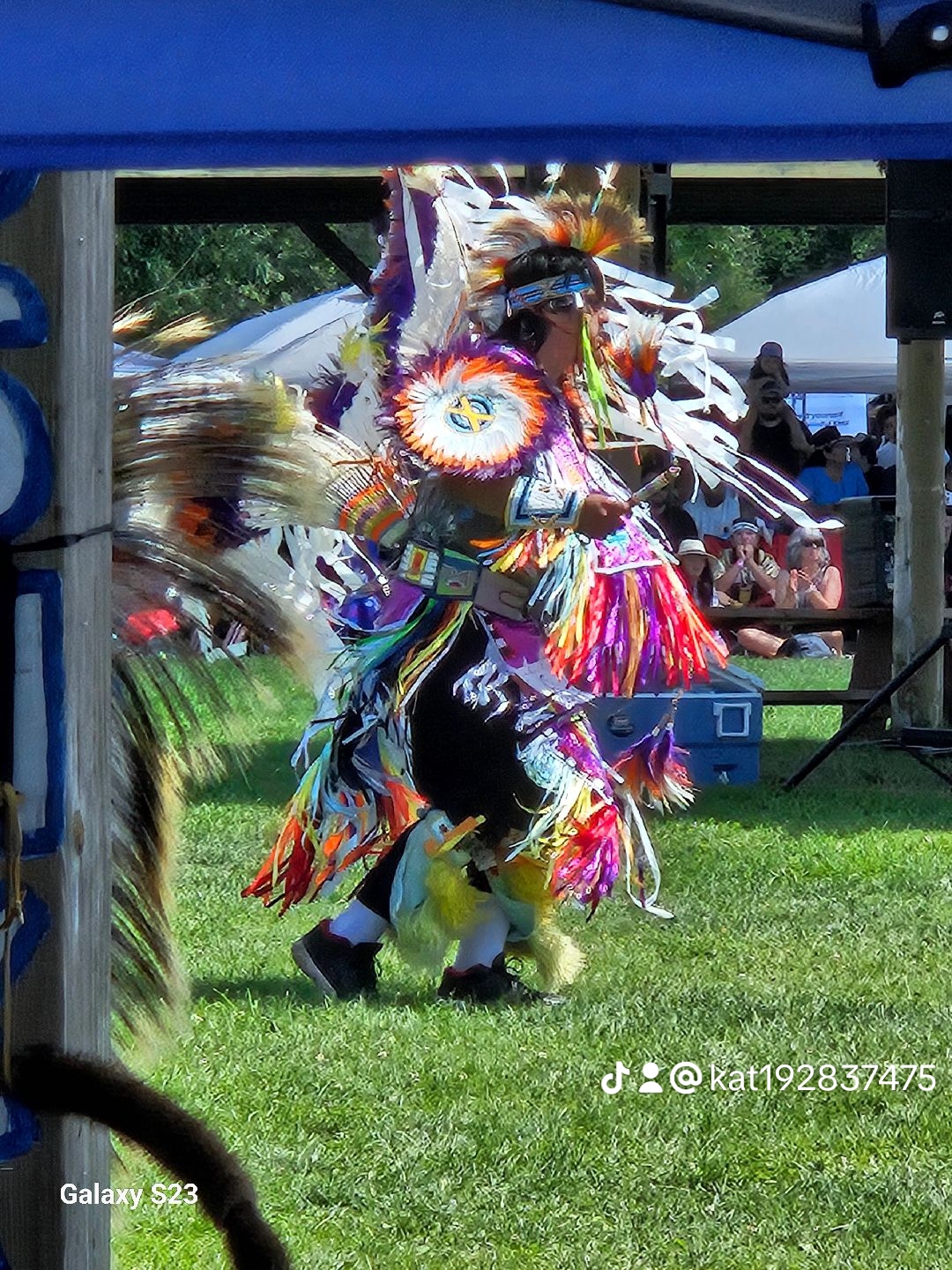 4bf9fb926e974f166f6d812d5cb94127_12 A group of Indigenous people celebrating in their traditional garments.